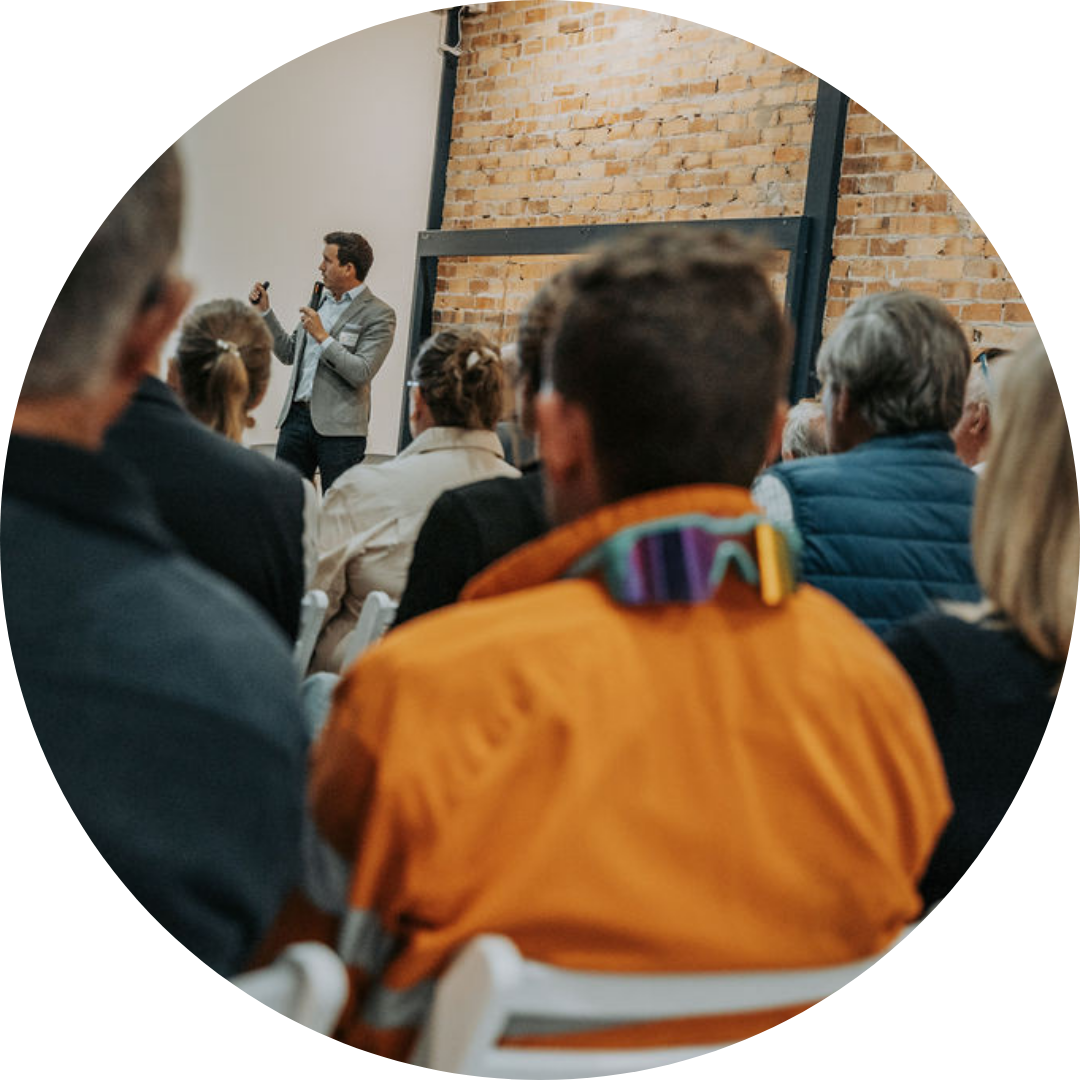 man delivering financial advice to diverse audience